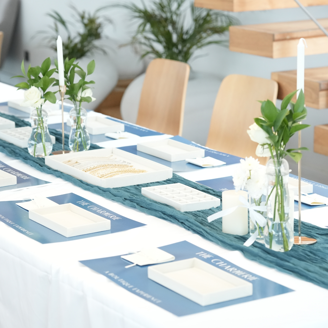 Decorative table setting with place cards, candles, and floral arrangements in a modern indoor setting for charms jewelry making workshop in duab for EID 2026